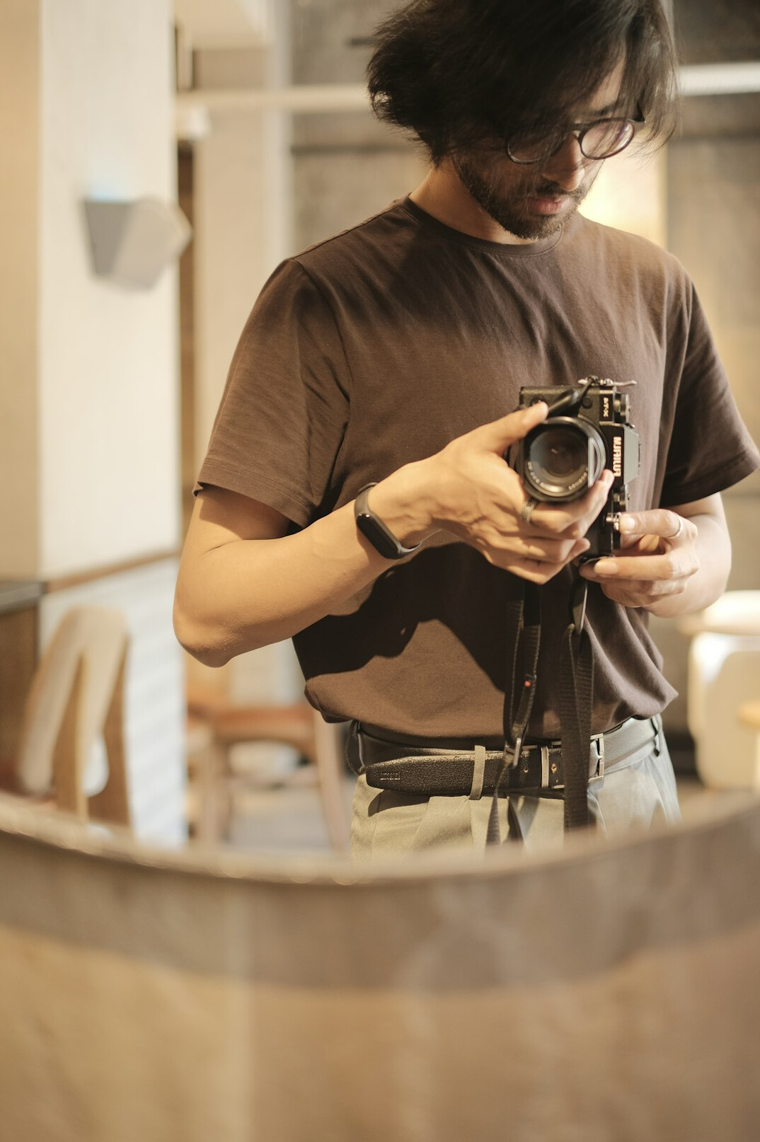 Camera operator filming from behind in a television studio